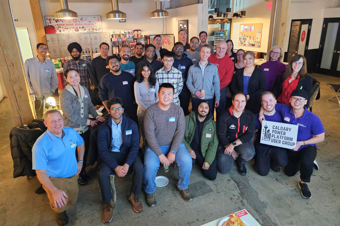 Calgary Power Platform User Group (CPPUG) End of Year Networking Event 2024 Group Photo featuring David He and Ryley Bauer of Bauer Automate